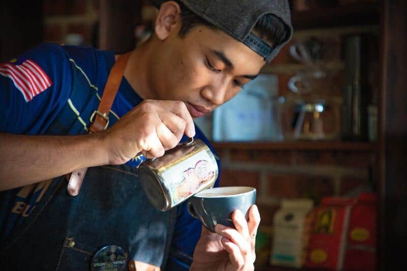 barista pouring coffee