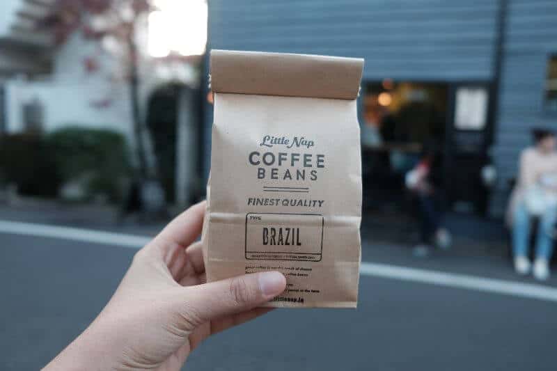 Coffee beans in a bag held by a person